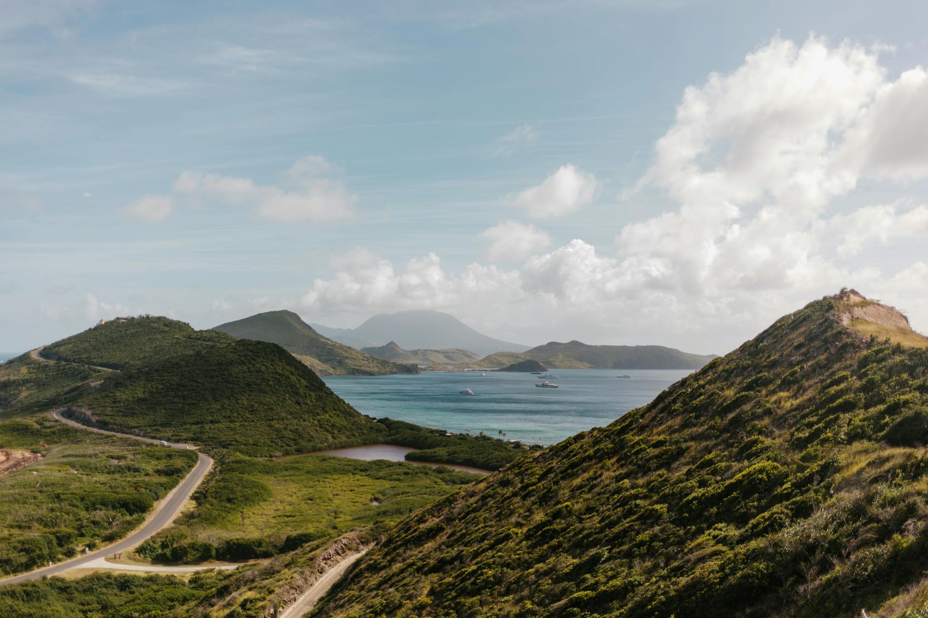 green mountains near the ocean